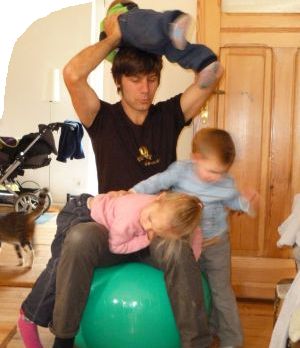 Daddy with kids playing with gym ball