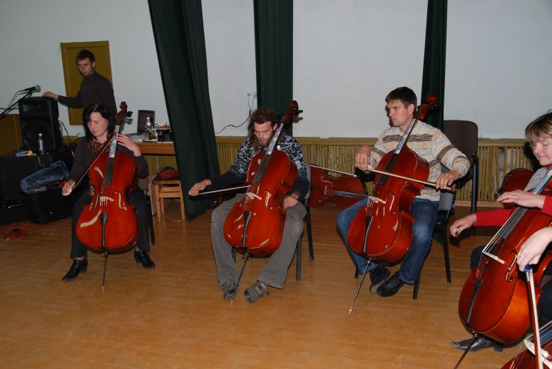 boys in a circle learning cello