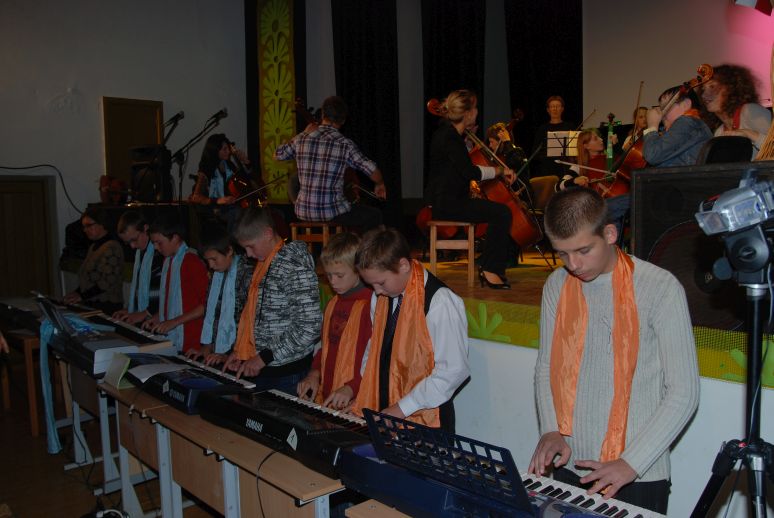 row of keyboard playing boys