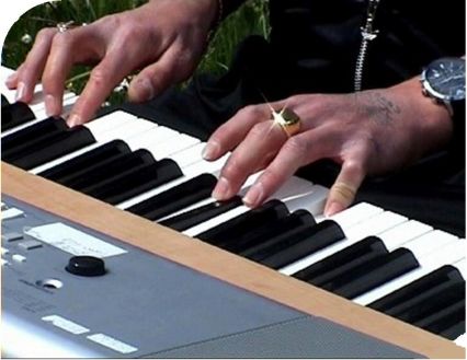 hands with tatoo playing piano