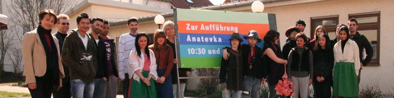 group of people with Anatevka announcement