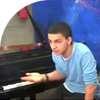 young migrant with grand piano explaining